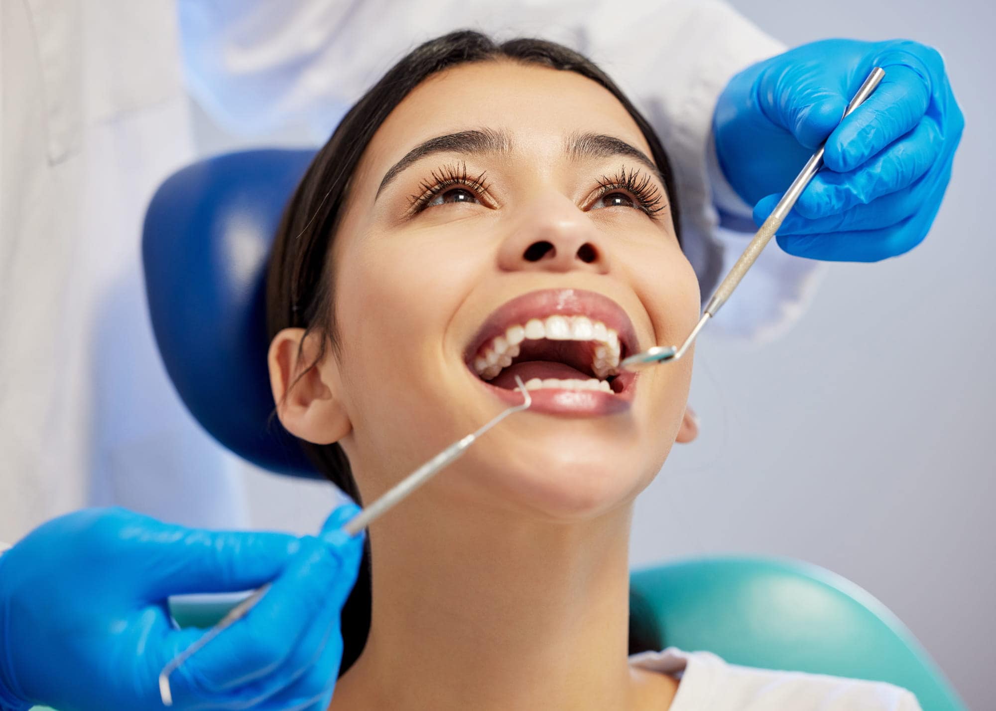 Dental hygienist performing a professional dental cleaning at The Dental Lounge in Windsor